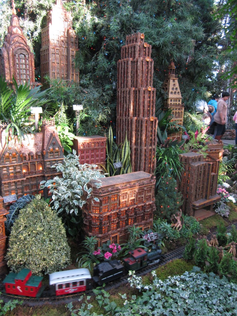 A toy train motors past the Manhattan skyline at the New York City Botanic Garden in the Bronx