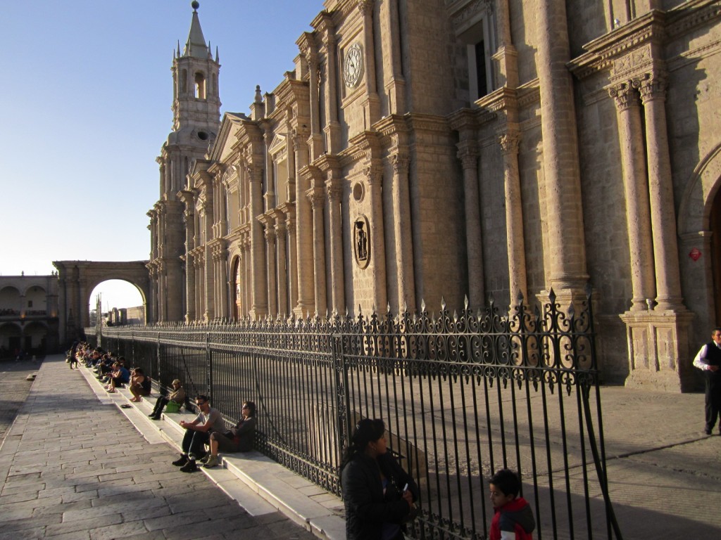 Locals and tourists alike enjoy relaxing on the steps of Arequipa's La Catedral