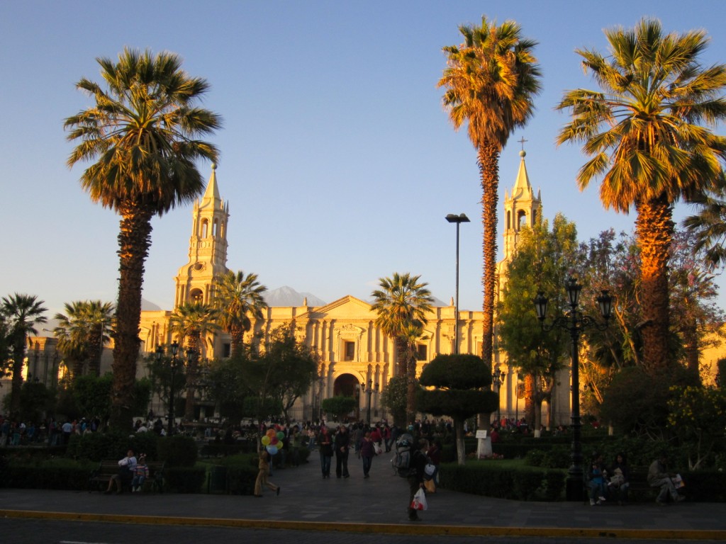 The sun sets on the Plaza de Armas and Arequipa's majestic "La Catedral," with the El Misti volcano in the background. 